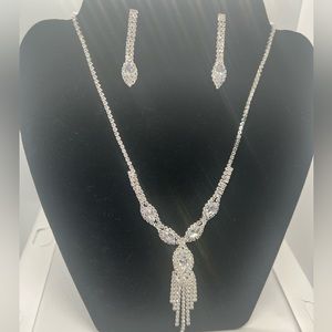 Necklace and earrings color silver.